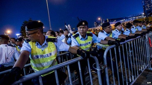 Police protect a cordon outside government offices in Hong Kong. 28 Sept 2014