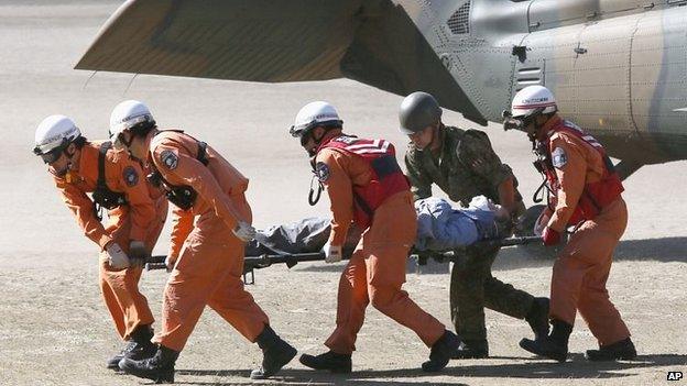 A climber recovered from the mountain is taken to hospital in Kiso (28 Sept)