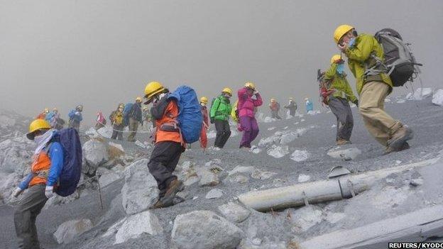 Climbers descending Mount Ontake through thick smoke