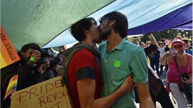 Two men kiss during the Pride Parade in Belgrade.