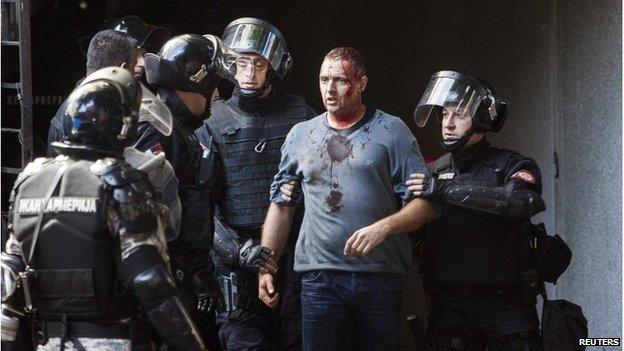 Riot police detain an anti gay activist