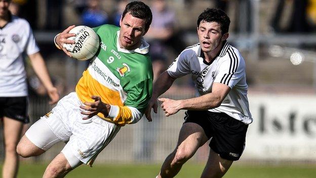 Carrickmore's Conor Gormley attempts to get past Omagh's Ciaran McLaughlin in the Tyrone Football Final