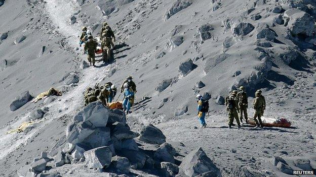 Bodies of victims brought down mountain. 28 Sept 2014