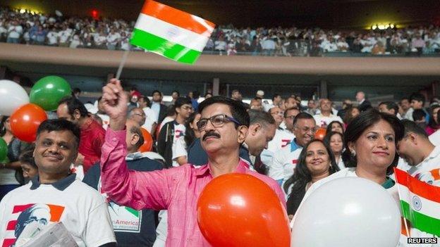 Audience members wave Indian flags and hold balloons during an event with India's Prime Minister Narendra Modi at Madison Square Garden in New York, during his visit to the United States, September 28, 2014.