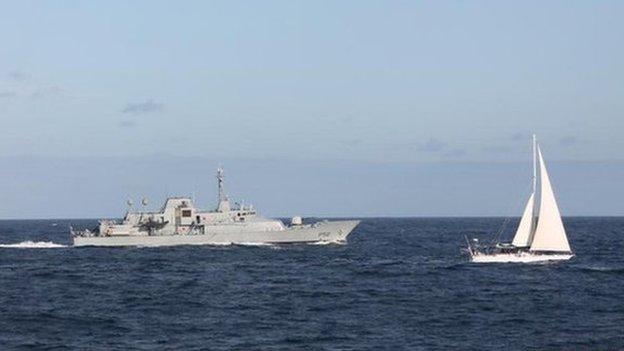 The Irish naval vessel - the LÉ Niamh, sails alongside the detained yacht Makayabella