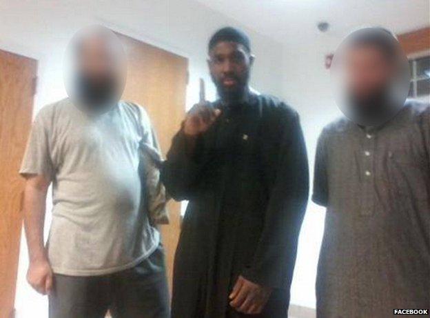 Alton Nolen makes a one-finger gesture at the mosque