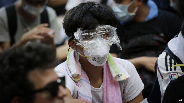 A protester with his face covered with plastic wrap to protect himself from tear on 29 September 2014