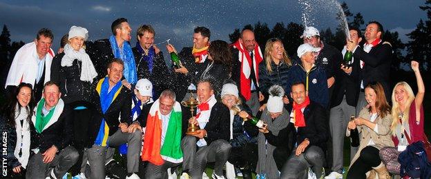 The European team celebrate their victory together with their partners