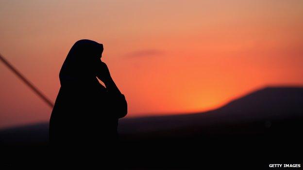 An Iraqi woman outside her tent at a temporary displacement camp. Thousands of people fled Iraq's second city of Mosul after it was overrun by IS