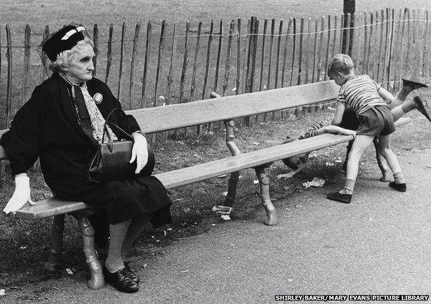 Elegant Elderly lady on a park bench with two unruly boys