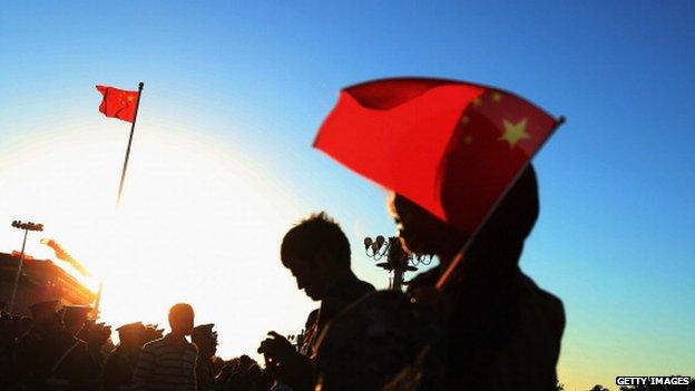 Chinese tourists wait for watching the customary ceremony of lowering flag at the Tiananmen Square on 28 September 2012 in Beijing, China.