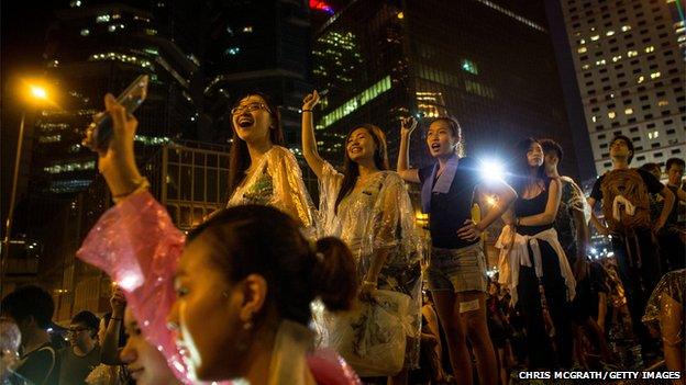 Protesters sing songs and wave their mobiles in the air in Hong Kong