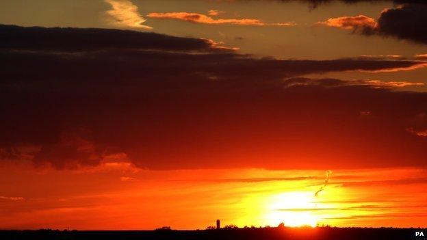 The sun sets over a field near Cambridge on September 26