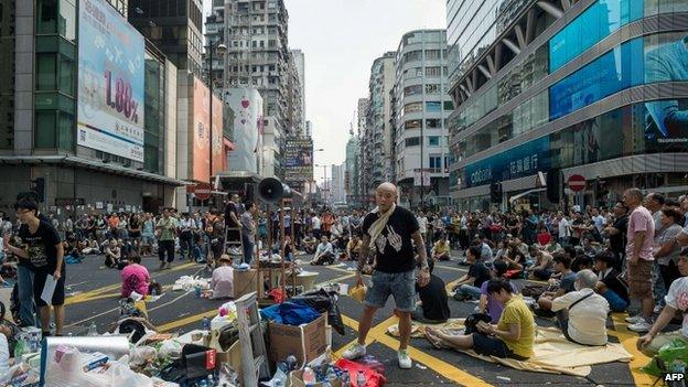 Pro-democracy demonstrators rest during a protest in Hong Kong on 30 September 2014