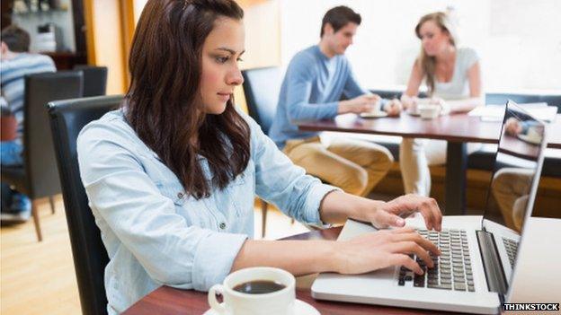 Woman in cafe using laptop