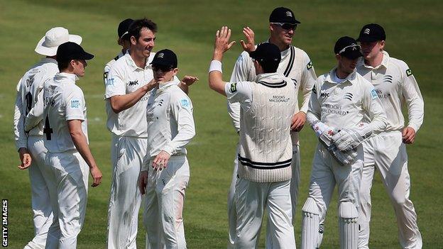 Middlesex bowler Tony Roland-Jones is congratulated by his teammates