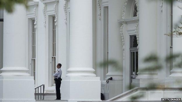 A member of the US Secret Service stands guard at the north entrance to the White House in Washington, DC 29 September 2014