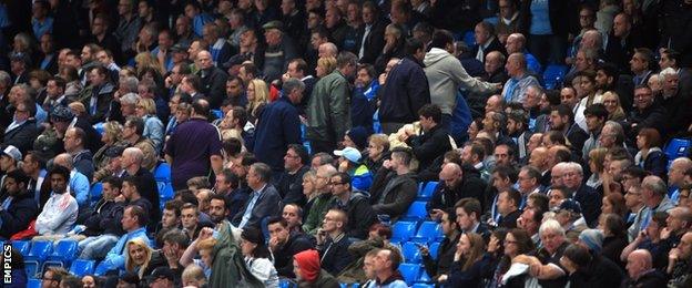 Manchester City fans leave early during their side's draw with Roma