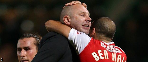 Charlton manager Bob Peeters and Tal Ben Haim embrace after victory at Norwich