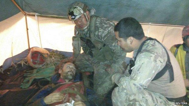 Rescue members talk to Spanish speleologist Cecilio Lopez-Tercero after he was rescued from a cave where he was trapped for 12 days, in Leymebamba, Chachapoyas, in this handout photograph distributed to the media on September 30, 2014