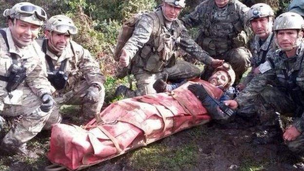 In this photo released by the Peruvian Air Force, officers pose for the picture with Spanish speleologist Cecilio Lopez after his rescue from inside the Inti Machay cave, in Leimebamba, Peru, Tuesday, Sept. 30, 2014