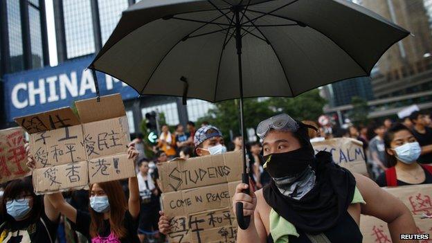 Protesters gather around the Golden Bauhinia Square before an official flag raising ceremony to commemorate the Chinese National Day in Hong Kong, on 1 October, 2014