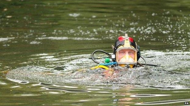 Police divers search the Grand Union Canal