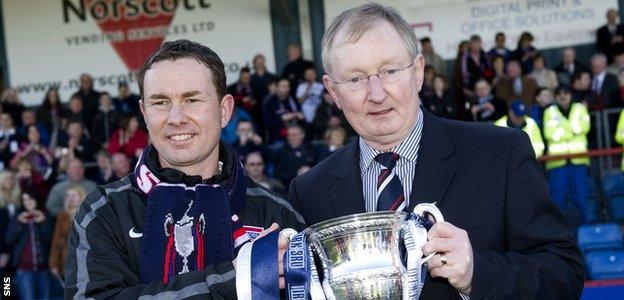 Derek Adams and his director of football father, George, with the Division One trophy