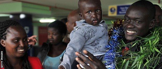 Kimetto and his family pose for photographers on their return to Nairobi