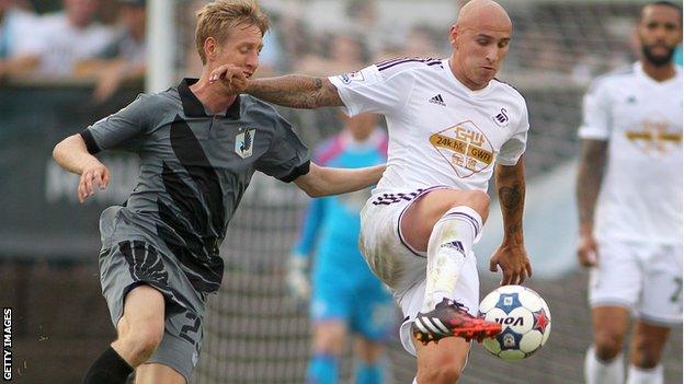 Jonjo Shelvey in action against Minnesota FC's Greg Jordan