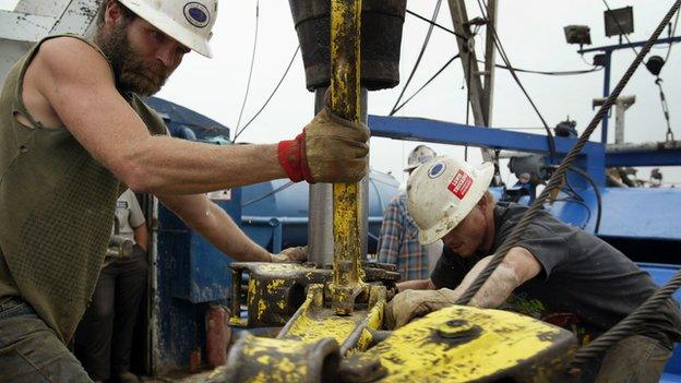 Two men operate an oil rig in Illinois.