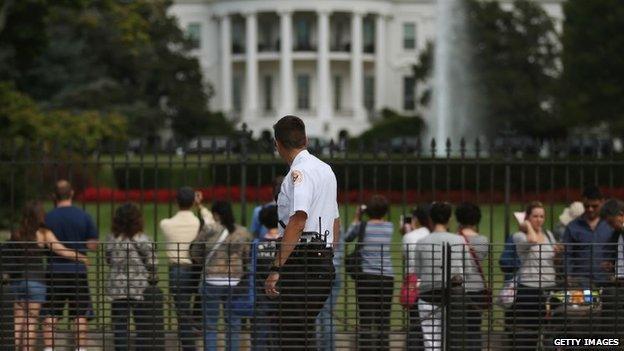 A member of the US Secret Service watches as tourist visit the south side of the White House September 30, 2014 in Washington, DC.