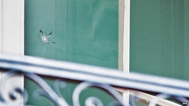 A bullet hole is seen in the window on the residential level on the south side of the White House 11 November 2011