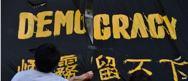 Protesters hang a banner in Hong Kong