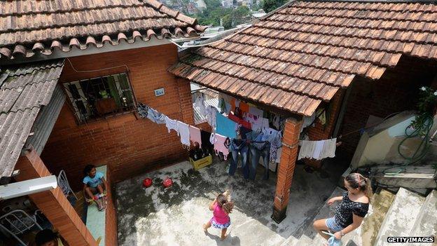 Members of the Neves family at their new home which they purchased through the Bolsa Familia programme, picture from 19 October 2013