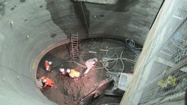 Men digging out the lift shaft for Green Park station