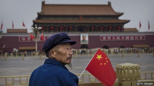 Man with flag in Beijing on China's 65th National Day, 1 October, 2014