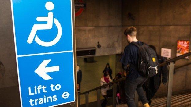 Sign at top of Westminster tube station reads "Lift to Trains"