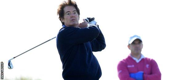 Paul McGinley looks on as Kyle MacLachlan plays a shot