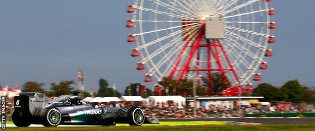 Lewis Hamilton drives past the iconic ferris wheel at Suzuka.