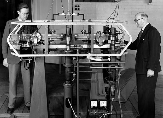 1956: The original caesium resonator which led to the development of the atomic standard time, with J V L Parry (on left) and L Essen, 1956