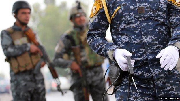 An Iraqi policeman holding a fake bomb detector