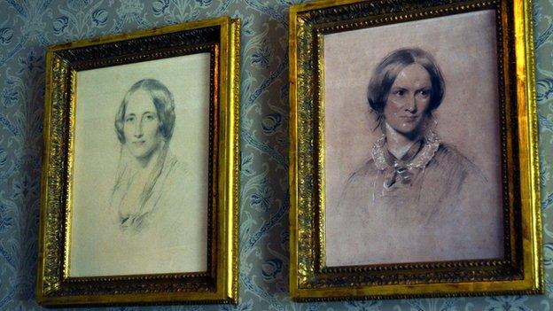 Portraits of Elizabeth Gaskell and Charlotte Bronte on the drawing room wall