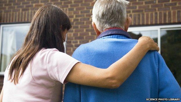 Woman caring for an elderly man