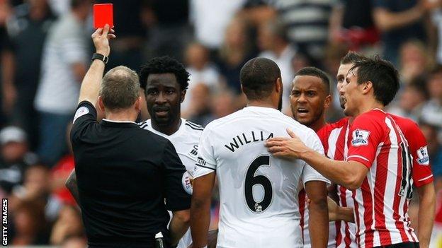 Wilfried Bony is shown a red card