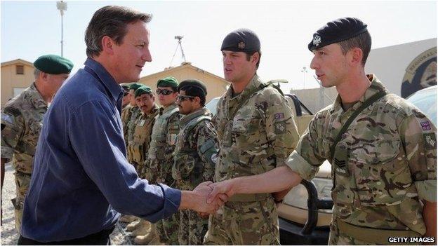 David Cameron shakes hands with a British soldier at Camp Bastion