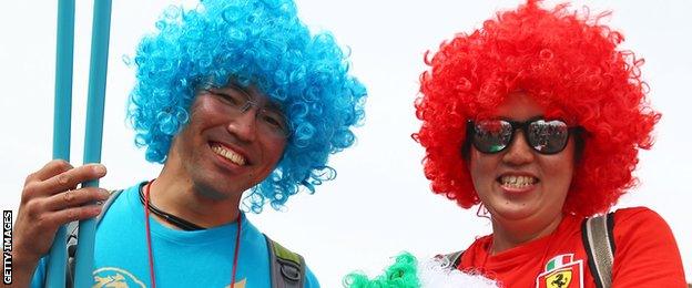 Japanese fans show off their multi-coloured wigs in support of their favourite teams