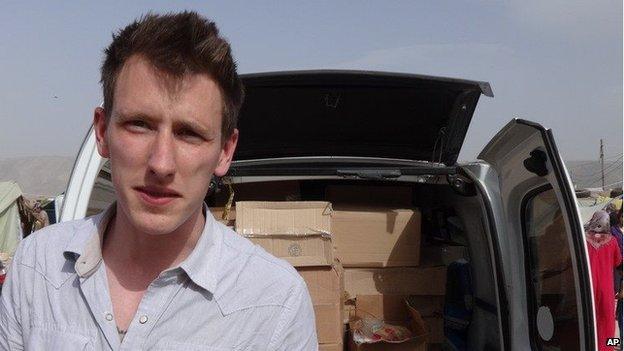 An undated photo provided by Kassig family shows Abdul-Rahman Kassig standing in front of a truck filled with supplies for Syrian refugees.