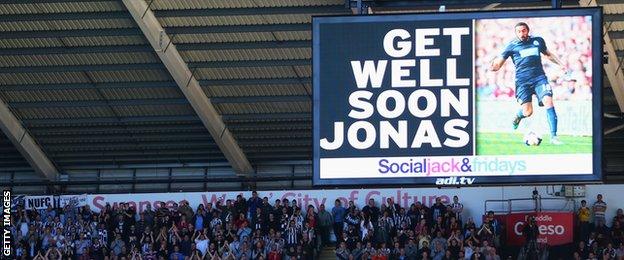 Swansea's scoreboard displays a message for Newcastle's Jonas Gutierrez