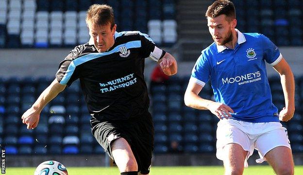 Ballymena United's Allan Jenkins in possession against Stephen Lowry of Linfield